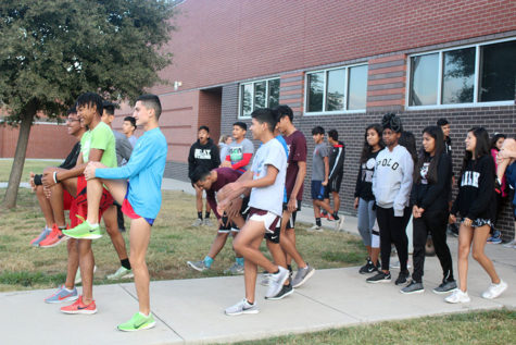 The cross country team warms up during practice before school on Thursday, Oct. 17.