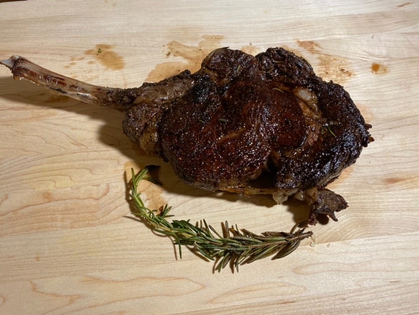 Tomahawk cooked and plated by senior Erick Nguyen sits on a cutting board.