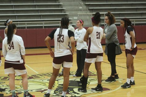 Juniors Kaitlyn Blair, Eryka Patton, Laila Lawrence, Haley Allen and the rest of the team listen to a speech given by head coach Sally Allsbrook during practice on Wednesday, Feb. 19.