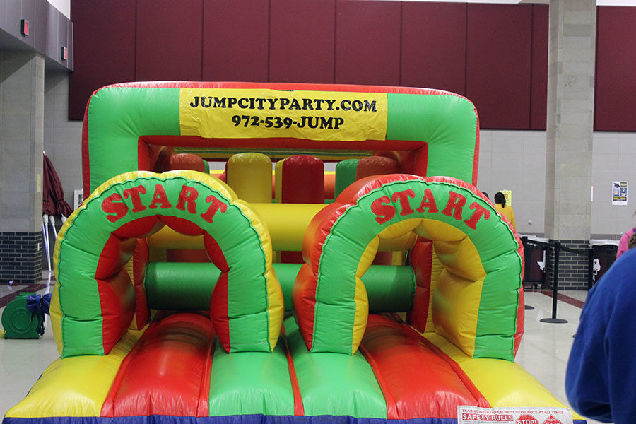 A bounce house is set up in the cafeteria for kids to enjoy at the Halloween carnival.