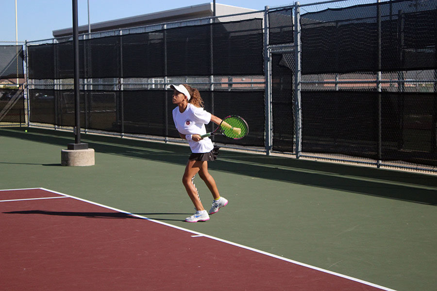 Sophomore Amber Rhoades recoils after forehand return.