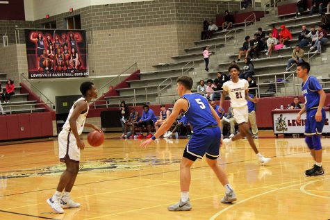 Sophomore Keyonte George (1) dribbles the ball as he looks for an open teammate during the game against R.L. Turner on Tuesday, Dec. 17.