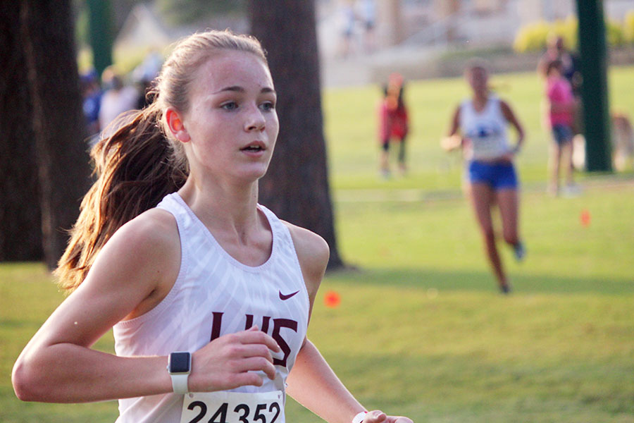 Sophomore girls varsity runner Trinity Trotter races to catch up with first place at the Marcus Invitational on Friday, Sept. 18. Trotter won the varsity girls’ division with a time of 11:31.86.