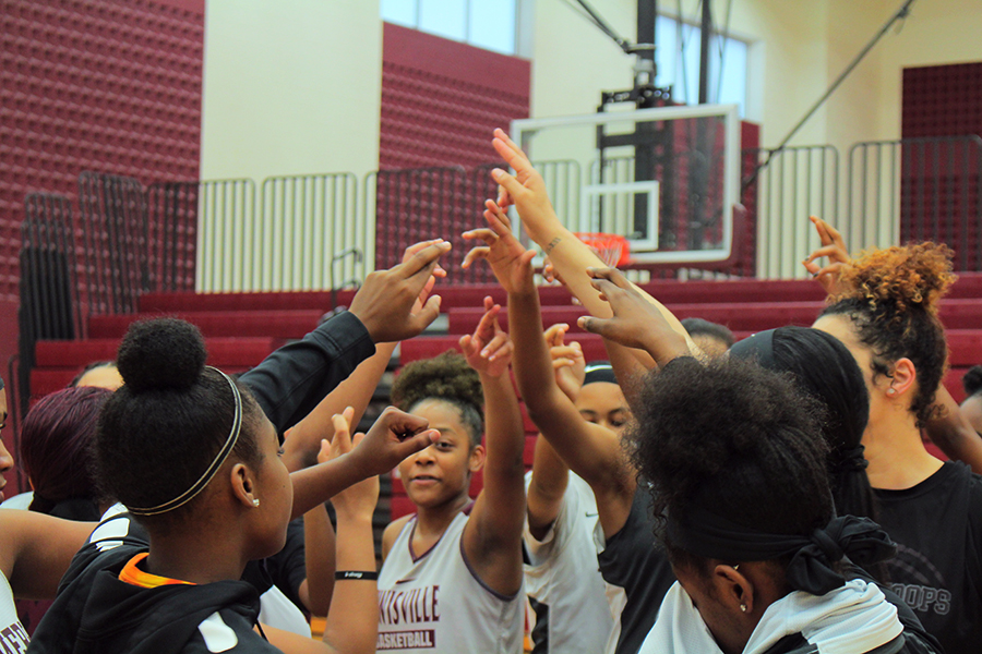 Girls basketball players huddle together after first period practice on Wednesday, Feb. 5.