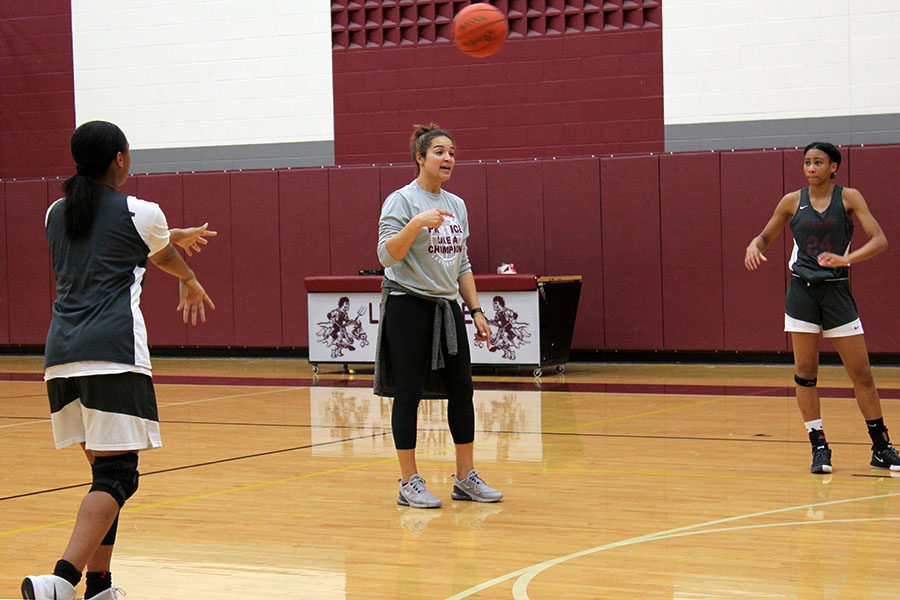 Freshmen Mya Dotson and Seimone Griffin work with coach Brittany Foster during morning practice on Wednesday, Nov. 5.