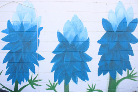 A close up view of the blue flower mural painted by senior Gloria Montellano.