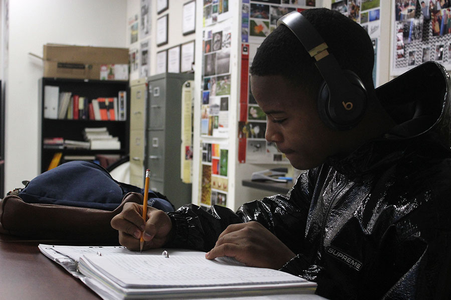 Junior Keith Coleman focuses on writing lyrics while listening to music.