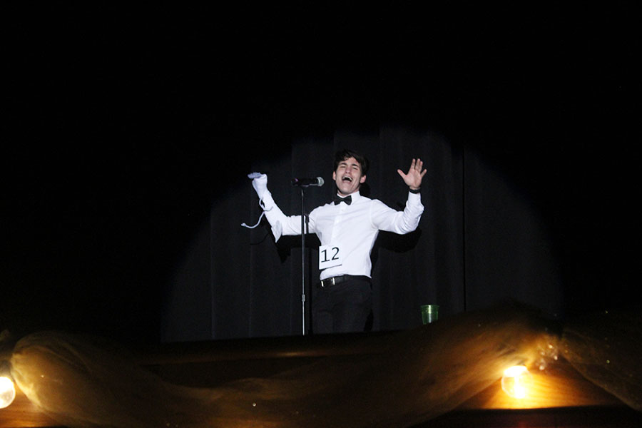 Senior Jimmy Piraino sings Man or Muppet from the Muppets with his sock puppet for the talent portion.