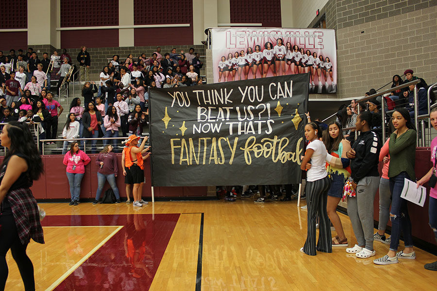 The boneheads reveal the banner for the football game.