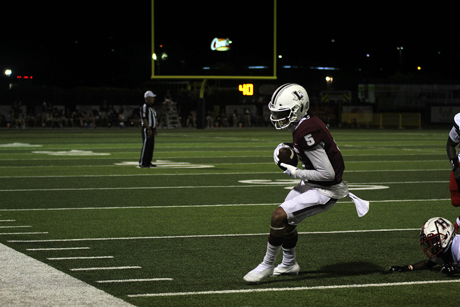 Senior wide receiver Isiah Stevens catches the ball leading to a touchdown during the game against Rockwall Heath on Friday, Sept. 25. 