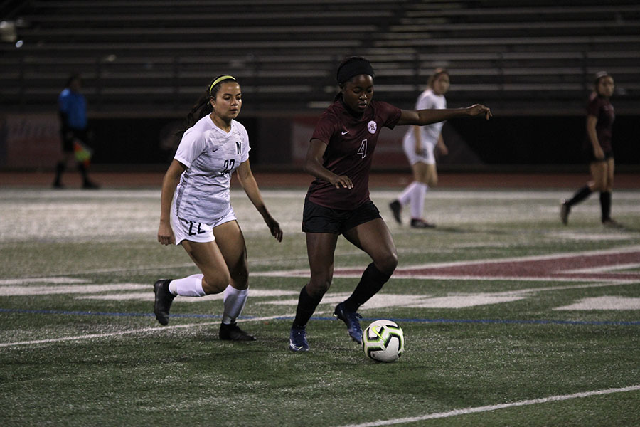 Junior Halana Stroud (4) runs after stealing the ball from the Nimitz player during the home game on Friday, March 6.