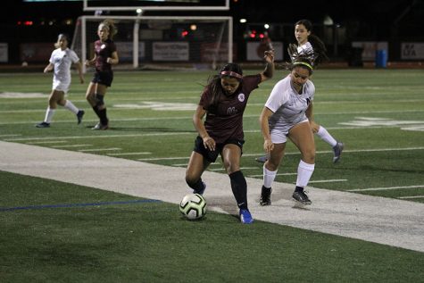 Junior Mia Espinoza (16) guards the ball from the opponent. 
