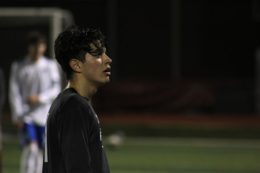Senior captain Ethan Carbajal (21) looks to the crowd during the game.