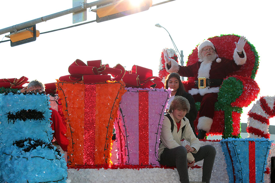 Santa Claus waves at the parade attendees.