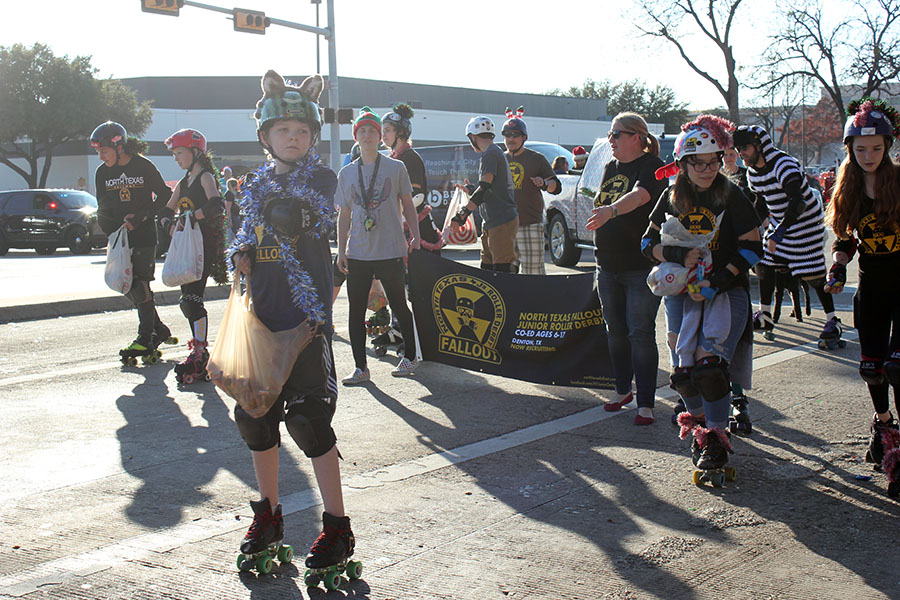Skaters from the North Texas Fallout Junior Roller Derby get ready to throw candy.