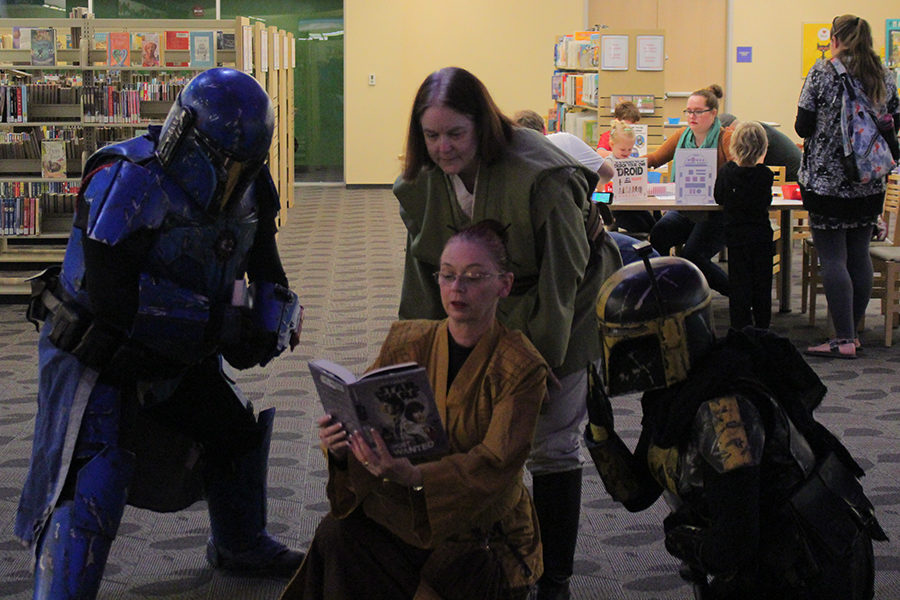 Members+of+Rebel+Legion+stand+around+one+of+cosplayers+reading+a+book+during+Star+Wars+Reads+Day+on+Saturday%2C+Oct.+12.