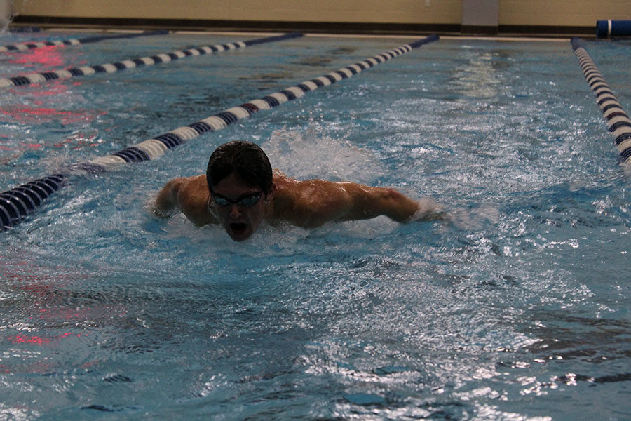 Senior Elliott Busby does a butterfly stroke during practice before school on Friday, Oct. 25.