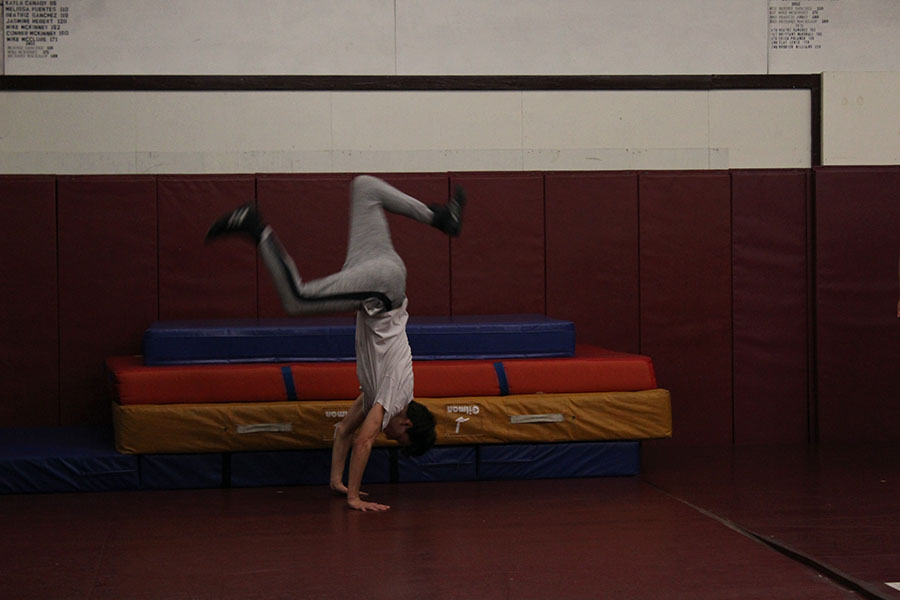 Senior Quentin Borchardt does a handspring during fourth period practice on Thursday, Nov. 21.