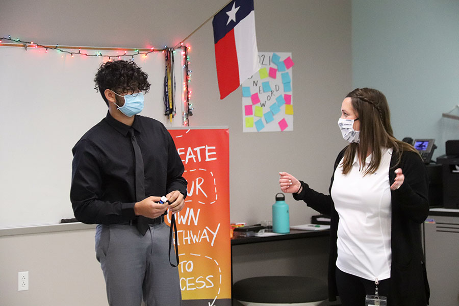 Senior Akash Chinta talks with INCubator teacher Valerie Cooper about his business to the board of advisers on Tuesday, Feb. 2.