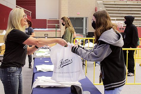 Senior Audrey Patelski picks up her cap and gown from a Jostens employee during block lunch earlier this semester. Graduation day is just one of a number of activities members of the Class of 2022 can take part in before their time in high school is done.