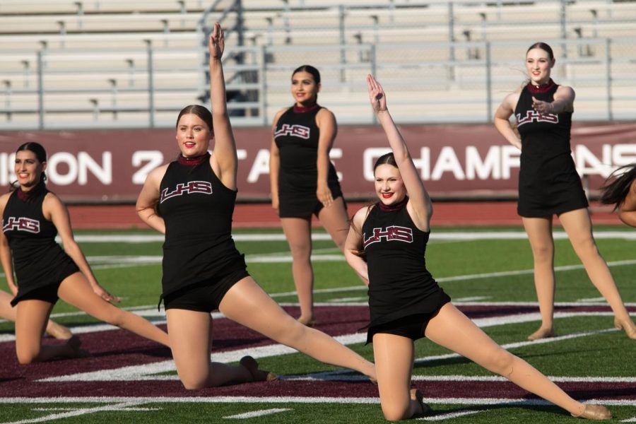 Sophomore Isabella Ortega and Katherine Gore lead the Farmertettes in their pre-show routine at the 2022 springball football game.