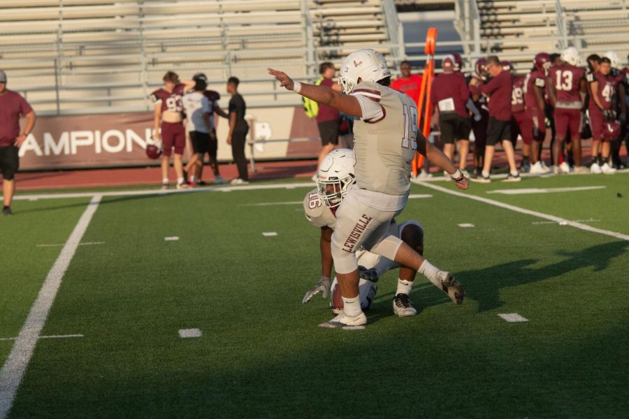 Varsity kicker Erick Arias plays on the offense team at the spring ball scrimmage game. The offense wore grey and defense wrote maroon.