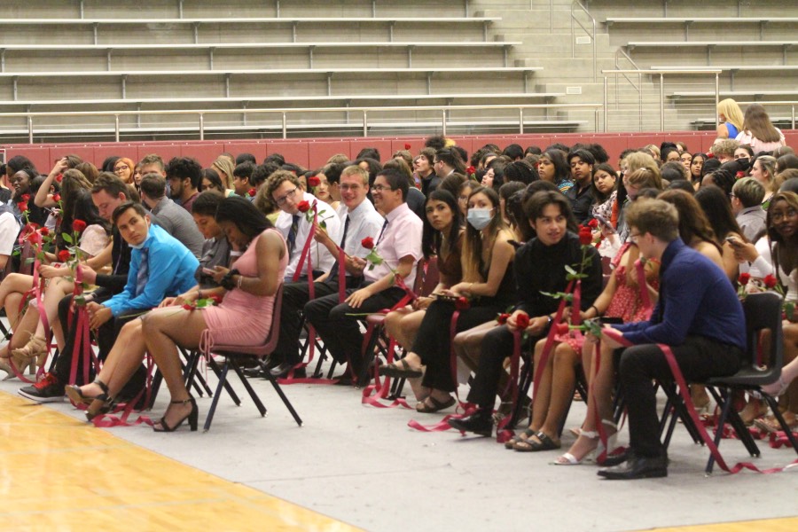 Seniors acquire their roses then sit in the arena and mingle before the ceremony begins.