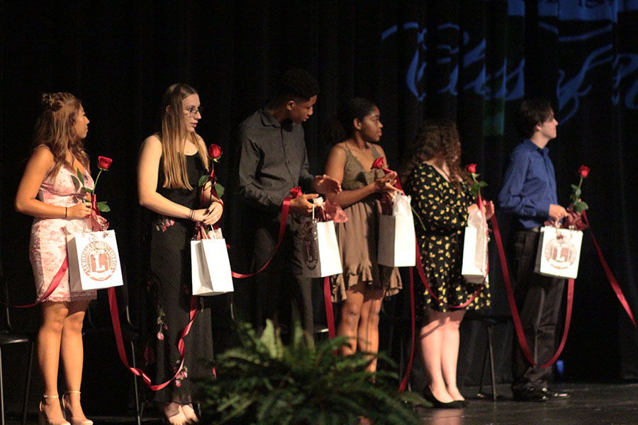 Senior student council officers receive gifts from administrators at the Rosecutting ceremony on May 17.