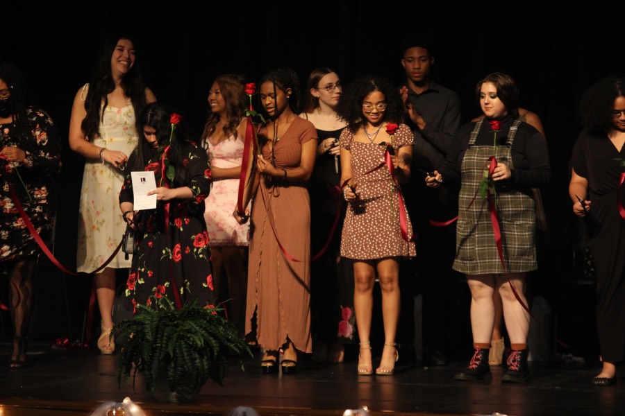 On stage, seniors cut their ribbons together in front of family and friends.