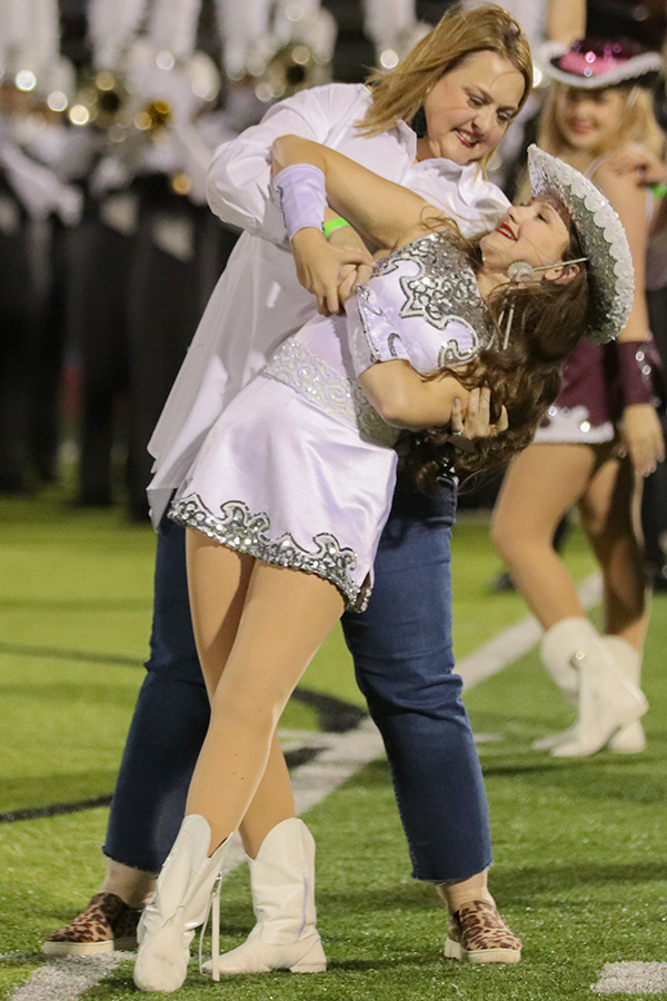 Junior lieutenant Katherine Gore performs alongside her mother Stephanie Gore during last Fridays home game. Toward the end of the family dance, Stephanie dipped her daughter as their finale move.