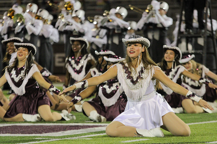Junior lieutenant Bella Ortega leads Farmerettes during the halftime show.