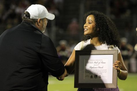 Principal Jim Baker shakes hands with new LHS Hall of Fame inductee Stephanie Umoh. Jeffery Price and Stuart Robertson also got inducted into the Hall of Fame that night.