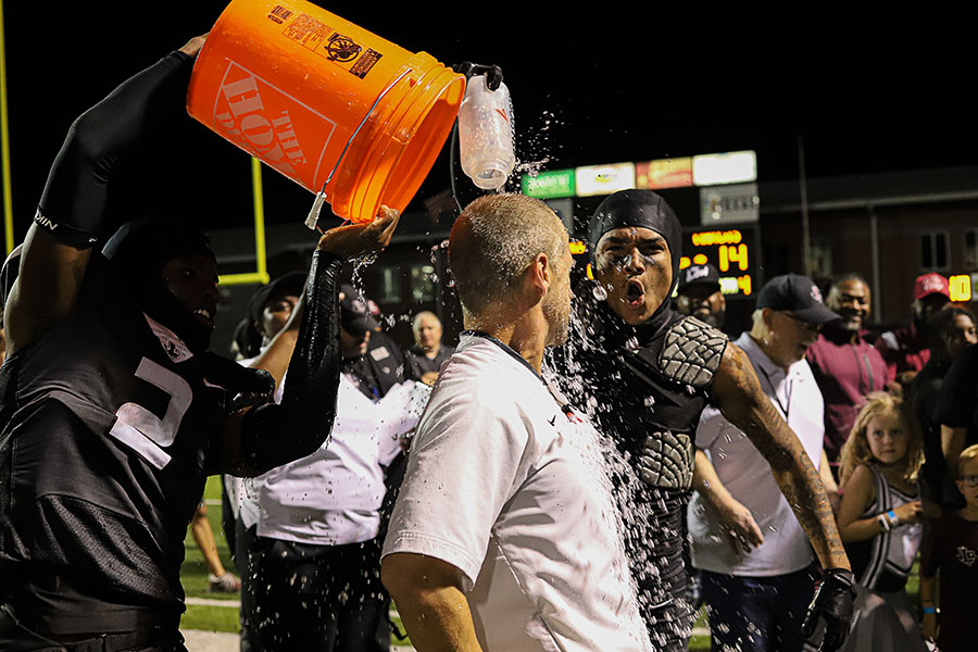 Football players dump a bucket of water on head coach Michael Odle after the win at Battle of the Axe on Oct. 21. Kicker Freddie Joya won the game with a field goal with less than a minute left in the fourth quarter.
