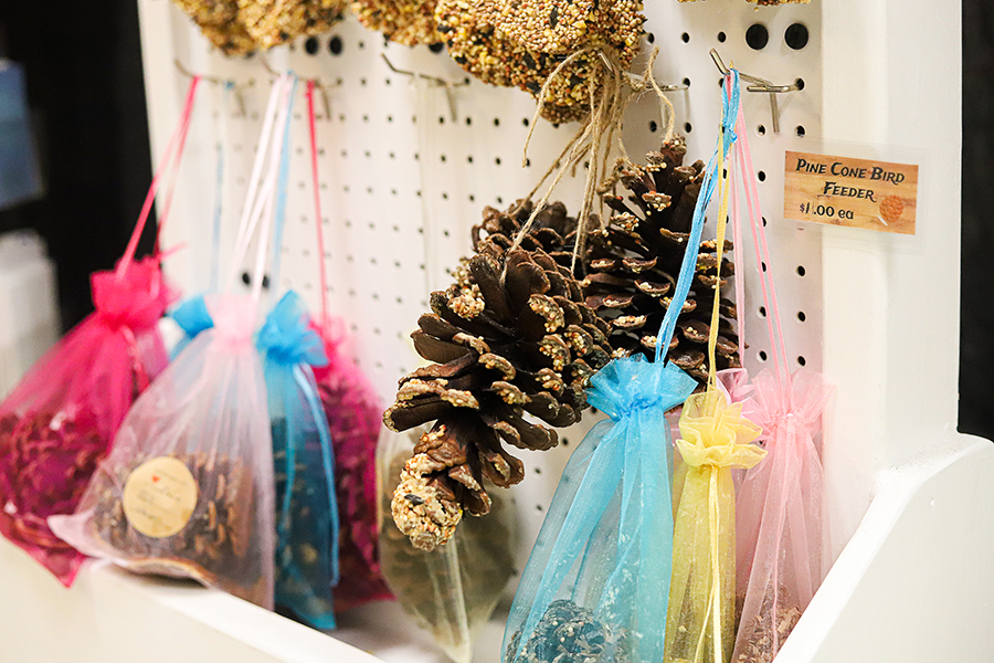 Farmers Trading Post offers safe treats for both dogs and birds. Bird feeders are from pinecones collected by the students.