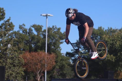 Professional BMX jumper Koji Kraft stops his bike on the front wheel. 