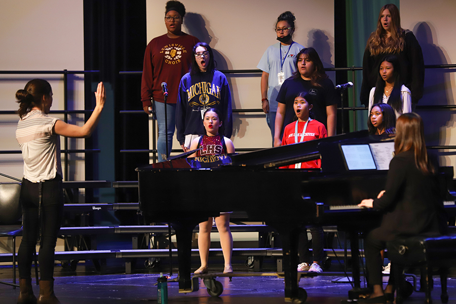 Associate Director Natalie Windle conducts the various choirs during after school rehearsal before the fall concert on Thursday, Oct. 6.