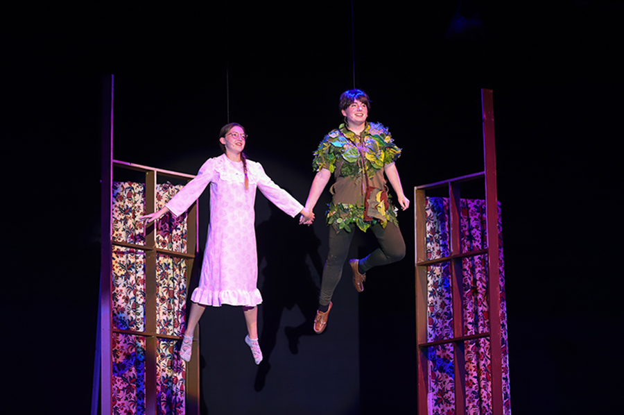 Wendy, played by Natalie Cauduro, and Peter Pan, played by Abigail Ehrenberg, fly around the room before leaving to go to Neverland.