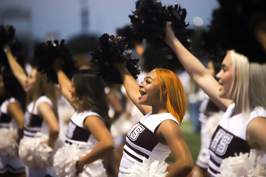 Junior Henrionna Johnson cheers alongside her team at the  Homecoming football game.