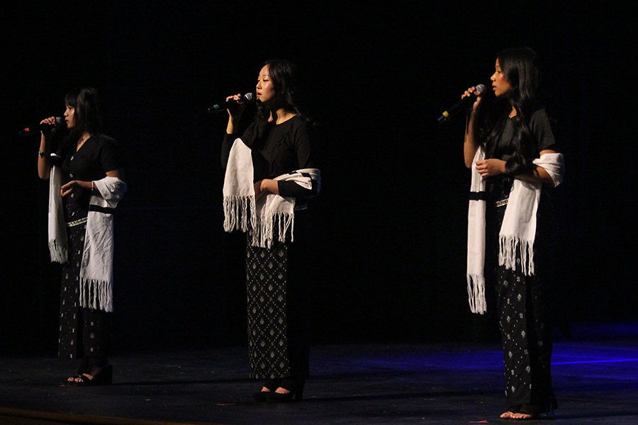 Students Sui Cin, Patricia Thang and Bawi Tha perform a trio song. 