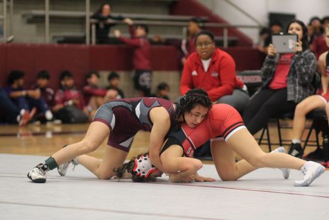 Senior Ileah Brown wrestles against her opponent at the match against Marcus on Nov. 30.