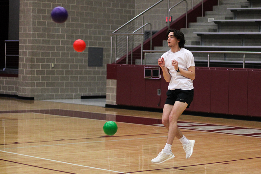 Senior Kolby Blair dodges flying balls in the final round of the dodgeball match on Friday, March 31.