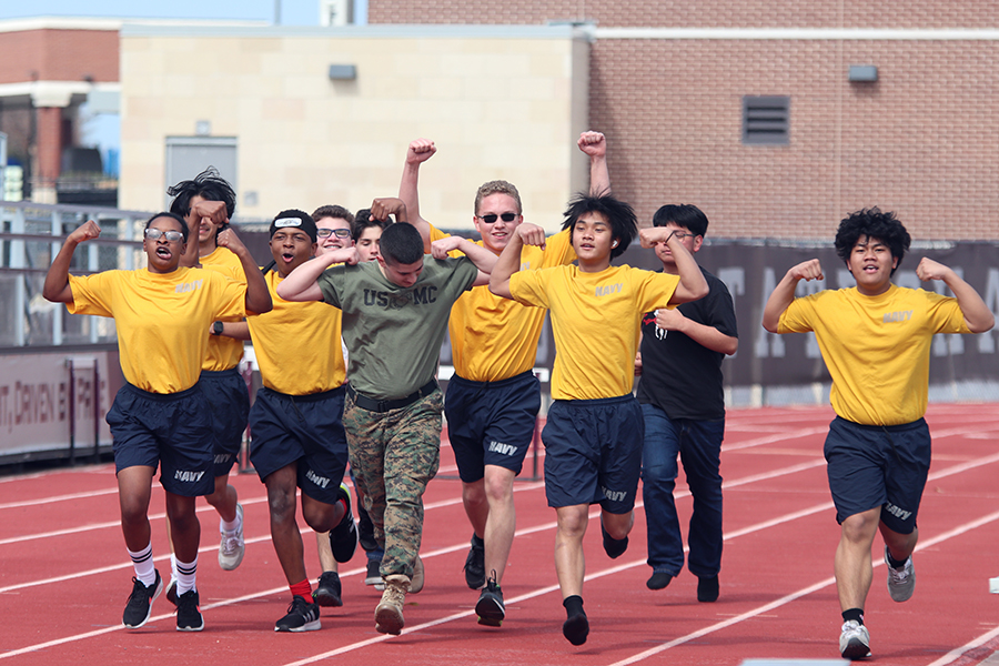 NJROTC+finishes+their+lap+around+the+field+from+afternoon+practice+with+Navy+Captain+John+Markley.