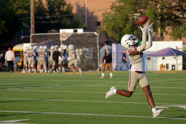 Junior Zachary Waller practices before the varsity game against Highland Park on Friday, Sept. 1. The game was delayed 30 minutes due to the heat.