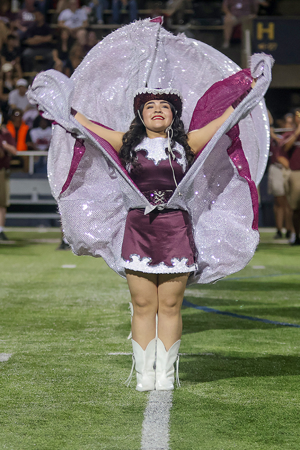 Varsity Farmerette Julie Lomas dances with the Farmerettes newly incorporated skirts during halftime at Highlander Stadium.