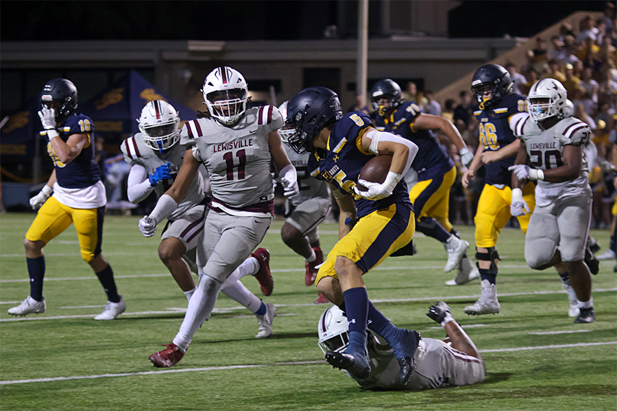 Defensive end Rhyan Sewell (11) prepares to make a tackle against Highland Park running back Keller Holmes (5) toward the end of the second quarter.
