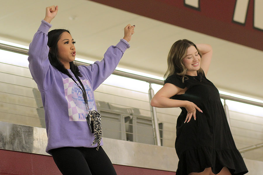 Farmerette coaches Hannah Pascual and Ally Turquette instruct the drill team on their newest routine from the stands of the arena during their daily third period practice.