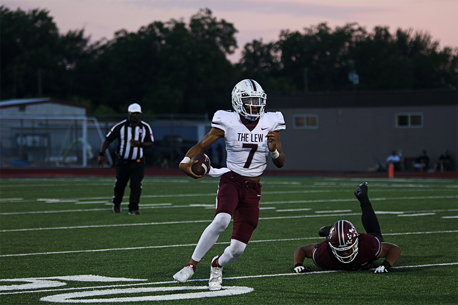 Senior quarterback Ethan Terrell (7) looks for first down yardage after dodging a Mesquite defender in the first quarter of the away game against Mesquite. 