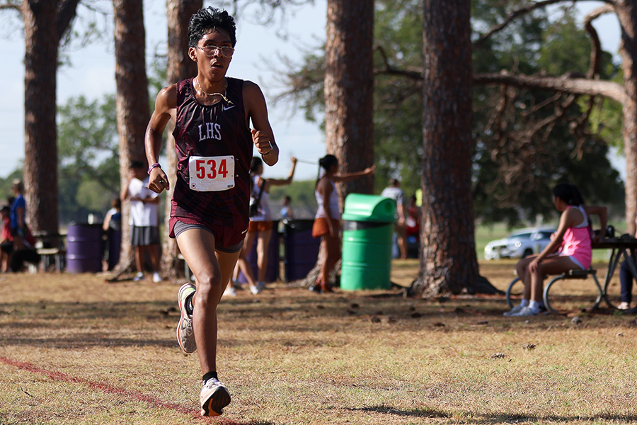 Junior Adrian Santos runs 3.12 miles in the varsity boys category in the race on Sept. 21.