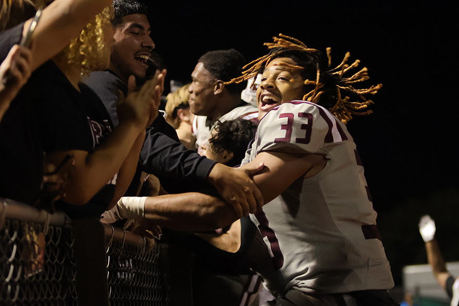 Defensive end Sean Oliver jumps into the Rowdy Crowd after the Battle of the Axe football game on Friday, Oct. 20.