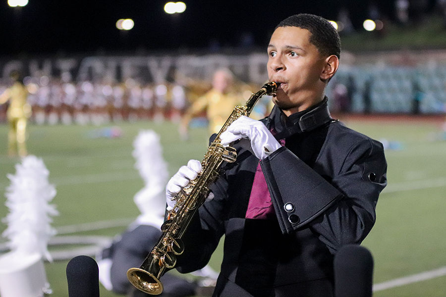 Head drum major Curtuss Mims performs a saxophone solo during the marching bands halftime performance at the Coppell football game last Friday.